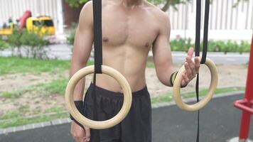 Asian man practicing gymnastics doing gymnastics bar and hoop exercises and stretching and resting for sports. video