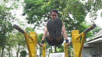 Asian man practicing gymnastics doing gymnastics bar and hoop exercises and stretching and resting for sports. video