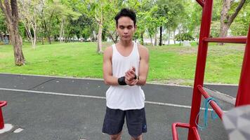 Asian man practicing gymnastics doing gymnastics bar and hoop exercises and stretching and resting for sports. video
