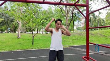 Asian man practicing gymnastics doing gymnastics bar and hoop exercises and stretching and resting for sports. video
