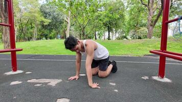 Asian man practicing gymnastics doing gymnastics bar and hoop exercises and stretching and resting for sports. video