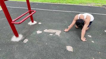 Asian man practicing gymnastics doing gymnastics bar and hoop exercises and stretching and resting for sports. video