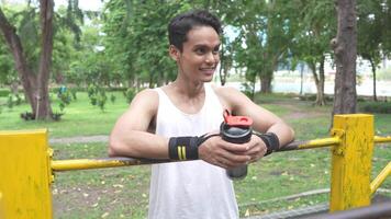Asian man practicing gymnastics doing gymnastics bar and hoop exercises and stretching and resting for sports. video
