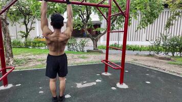 Asian man practicing gymnastics doing gymnastics bar and hoop exercises and stretching and resting for sports. video