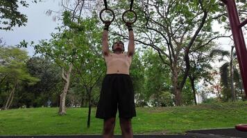 Asian man practicing gymnastics doing gymnastics bar and hoop exercises and stretching and resting for sports. video