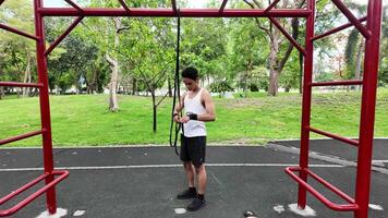 Asian man practicing gymnastics doing gymnastics bar and hoop exercises and stretching and resting for sports. video