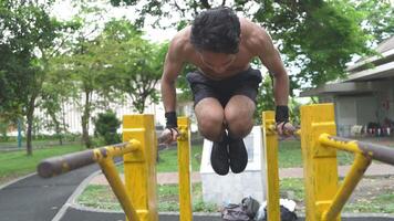 Asian man practicing gymnastics doing gymnastics bar and hoop exercises and stretching and resting for sports. video