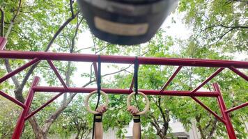 Asian man practicing gymnastics doing gymnastics bar and hoop exercises and stretching and resting for sports. video