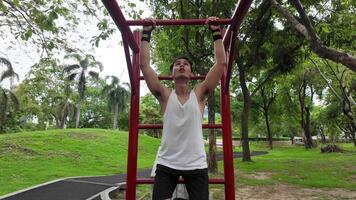 Asian man practicing gymnastics doing gymnastics bar and hoop exercises and stretching and resting for sports. video