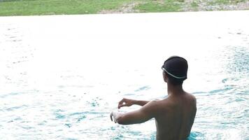 Asian men practicing swimming and preparing to play water polo and stretching and resting for water sports. video