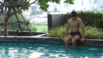 Asian men practicing swimming and preparing to play water polo and stretching and resting for water sports. video