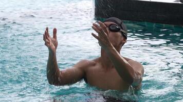 Asian men practicing swimming and preparing to play water polo and stretching and resting for water sports. video