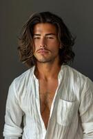 Portrait of a Young Man With Long Wavy Brown Hair and a White Button-Down Shirt photo