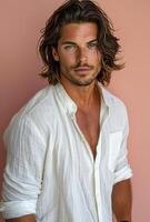 Portrait of a Young Man With Long Wavy Brown Hair and a White Button-Down Shirt photo