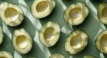 Green Ripe Avocados Arranged on Green Background photo