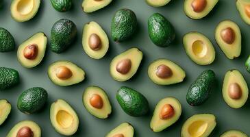 Green Ripe Avocados Arranged on Green Background photo