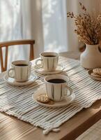 Two Striped Coffee Cups on White Striped Placemats at a Wooden Table photo