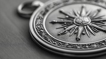 Close-up of a silver medallion with sunburst design. Detailed metalwork with selective focus on textured background. Jewelry design element. photo