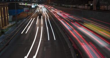 4K time-lapse dense car traffic with bright headlights in the city at night, public transport concept. Kiev district - Podil video