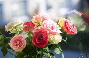 Bouquet of beautiful roses on the windowsill photo