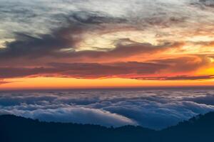 majestuoso amanecer hermosa nubes terminado el montañas crear un armonioso atmósfera, pintura un sereno y majestuoso escena de natural belleza foto