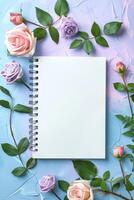 Spiral Notebook Surrounded by Pink and Purple Roses photo