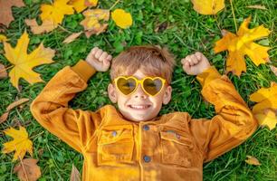 Little Boy in Yellow Jacket Wearing Sunglasses photo