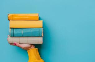 Person Holding a Stack of Books photo