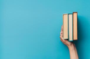 Person Holding a Stack of Books photo