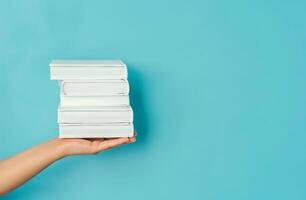 Person Holding a Stack of Books photo