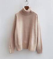 A Pink Sweater Hanging on a White Wall photo