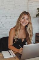 Woman Sitting at Table With Laptop photo