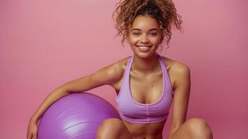 Woman Sitting on Top of a Pink Ball photo