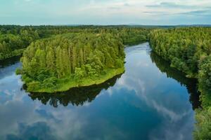 Breathtaking Landscape A Beautiful River Flows Through Charming Air and Lush Trees, Creating a Serene and Picturesque Natural Haven for All to Enjoy photo