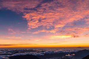 Majestic Sunrise Beautiful Clouds Over the Mountains Create a Harmonious Atmosphere, Painting a Serene and Majestic Scene of Natural Beauty photo