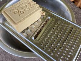 Grating laundry soap on a food grater photo