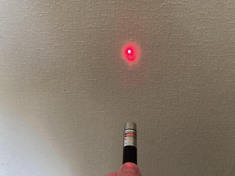 KYIV, UKRAINE - May 8, 2024 Handheld laser pointer shines a beam photo