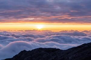 hermosa nubes terminado el montañas crear un armonioso atmósfera, pintura un sereno y majestuoso escena de natural belleza foto