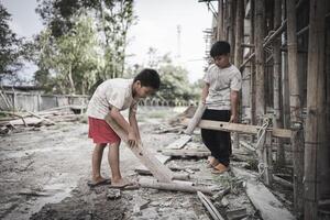 Poor children are forced to work in construction. are forced to work in the construction area. Human rights concepts, stopping child abuse, violence, fear of child labor and human trafficking. photo