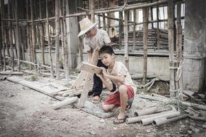 Poor children are forced to work in construction. are forced to work in the construction area. Human rights concepts, stopping child abuse, violence, fear of child labor and human trafficking. photo