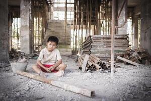 Two poor children are forced to work in construction. Poor children, poverty, Child labor, World Day Against Child Labour concept. photo