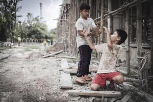 Poor children are forced to work in construction. are forced to work in the construction area. Human rights concepts, stopping child abuse, violence, fear of child labor and human trafficking. photo