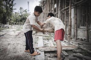 Poor children are forced to work in construction. are forced to work in the construction area. Human rights concepts, stopping child abuse, violence, fear of child labor and human trafficking. photo