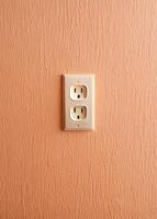 an electrical outlet on a wall with a white plug photo