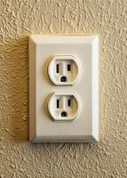 an electrical outlet with two white sockets photo