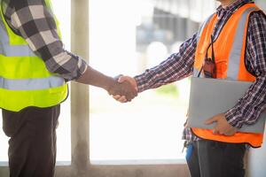 Architects and designers are talking about Construction plans before being delivered to the engineering team and foremen for construction. Audit concept Plans from a team of architects and designers photo