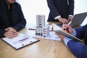 group of businessmen and investors discuss investing in real estate and jointly plan investments in construction projects of condominiums and apartments for sale and rent. investment advisory concept photo