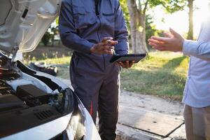 Technicians from service center inspect and assist customers cars that are having problems while traveling build confidence in customers who choose buy car from service center and receive help quickly photo