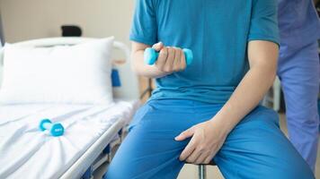 doctor is checking for muscle injuries and using dumbbells test injury and also help with physical therapy strengthen muscles because physical therapy will help strengthen muscles and help blood flow photo