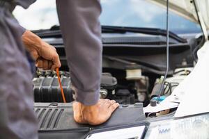 car service center mechanics are checking condition car and engine make sure they are ready use and in perfect condition according center warranty. periodic vehicle inspections for safety in driving. photo